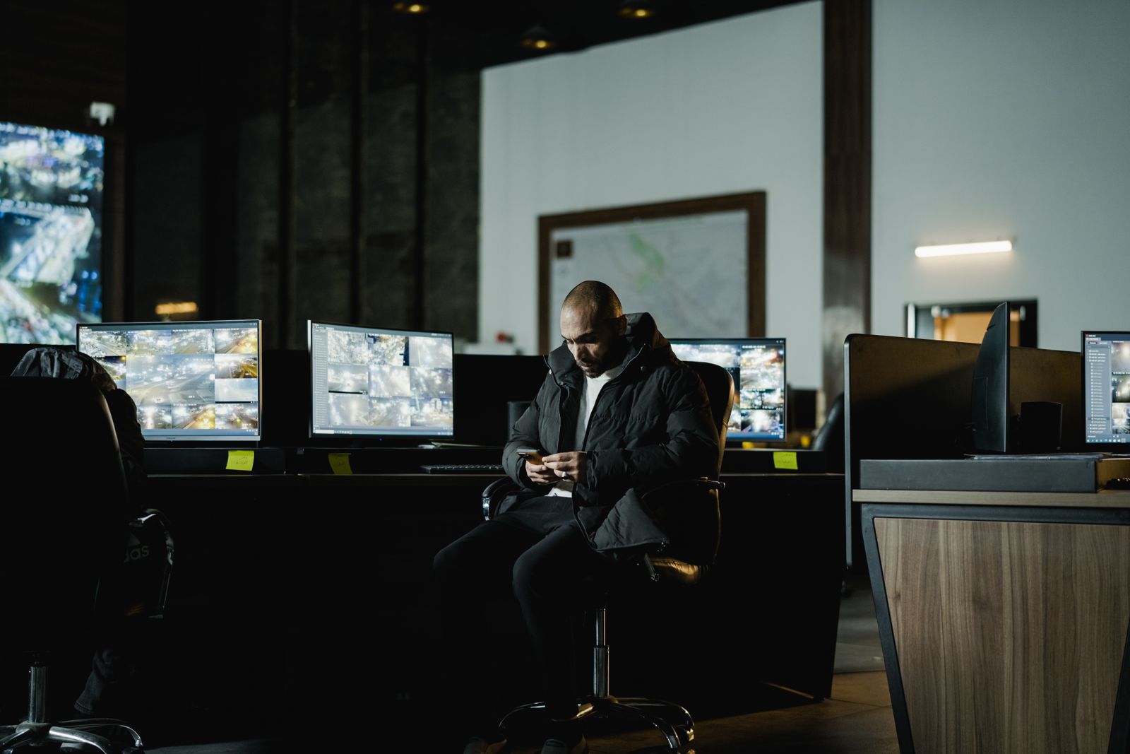 Security analyst reviewing intelligence briefs on monitors