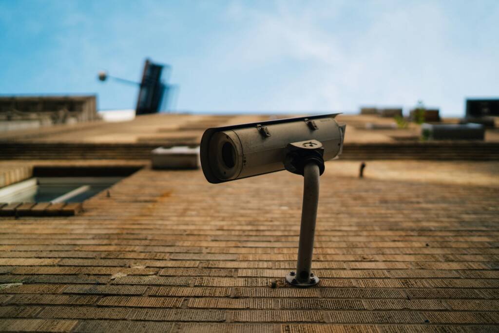 Outdoor CCTV security camera against a blue sky