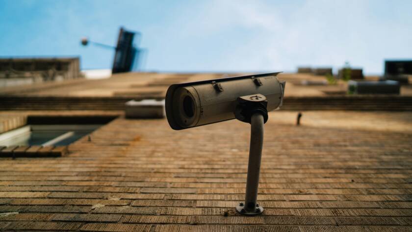 Outdoor CCTV security camera against a blue sky