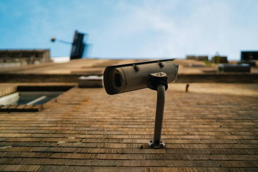 Outdoor CCTV security camera against a blue sky